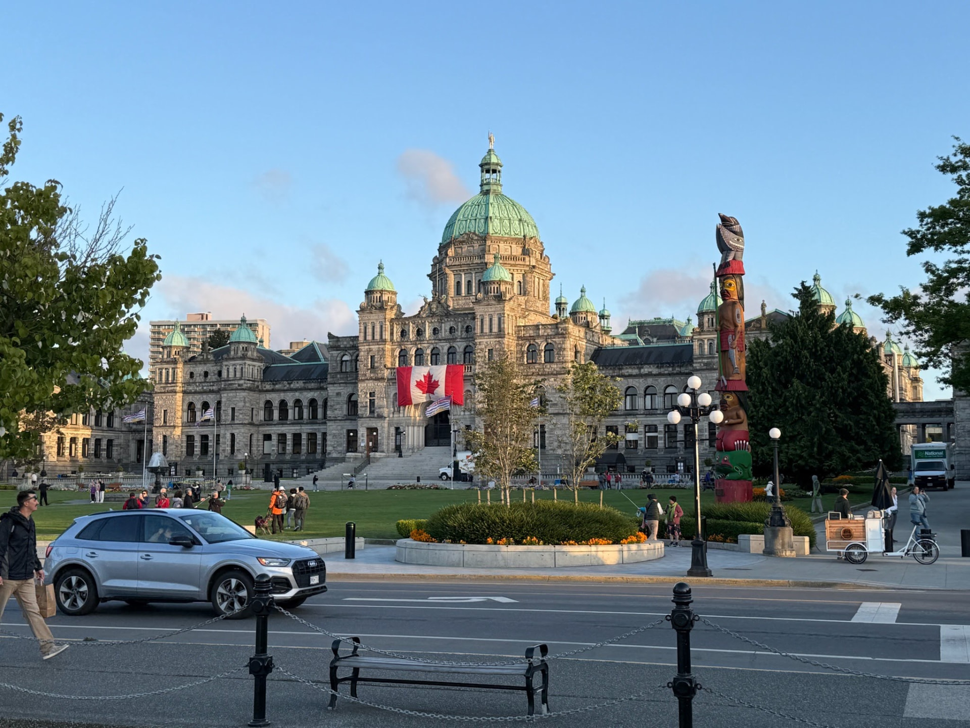 British Columbia Parliament Buildings with a totem pole in the foreground
