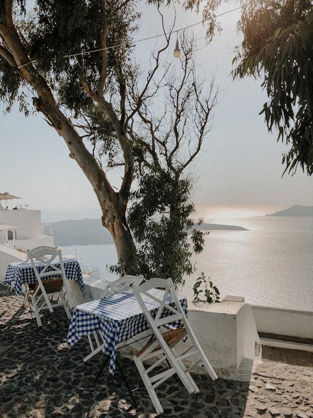 A taverna table under a tree overlooking the Aegean